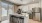 expansive kitchen with white cabinetry and kitchen island and quartz countertops