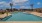 Resort-Inspired Pool Deck surrounded by palms and lounge seating