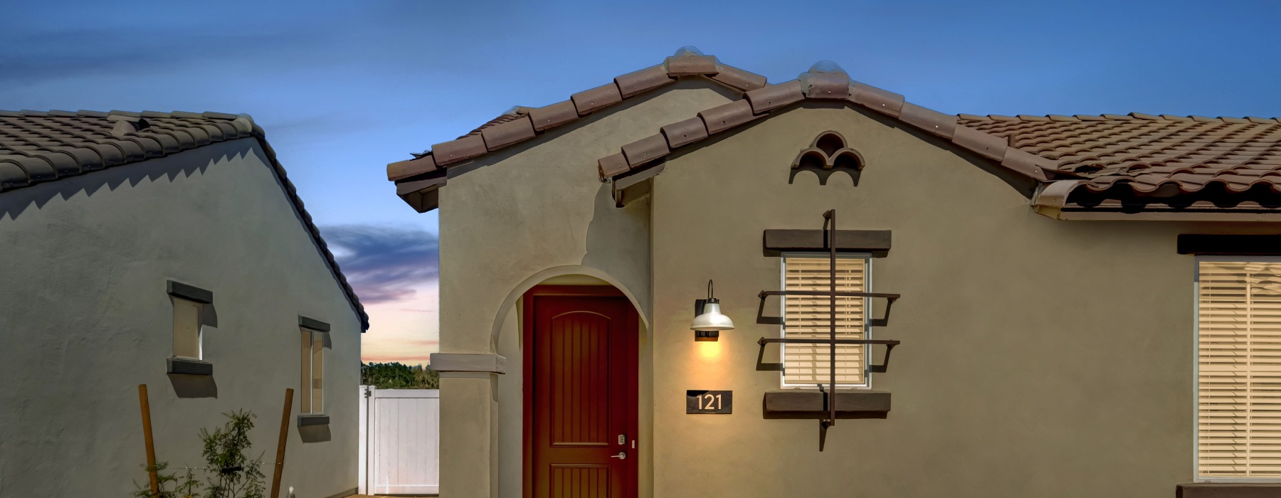 dusk shot of exterior home with red front door