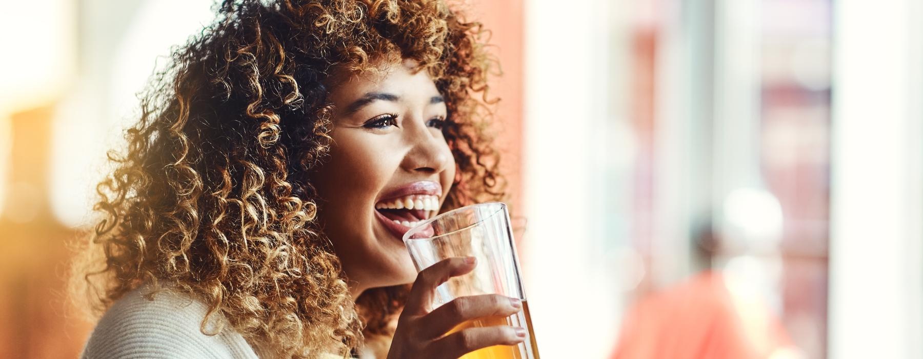 a woman holding a glass of beer