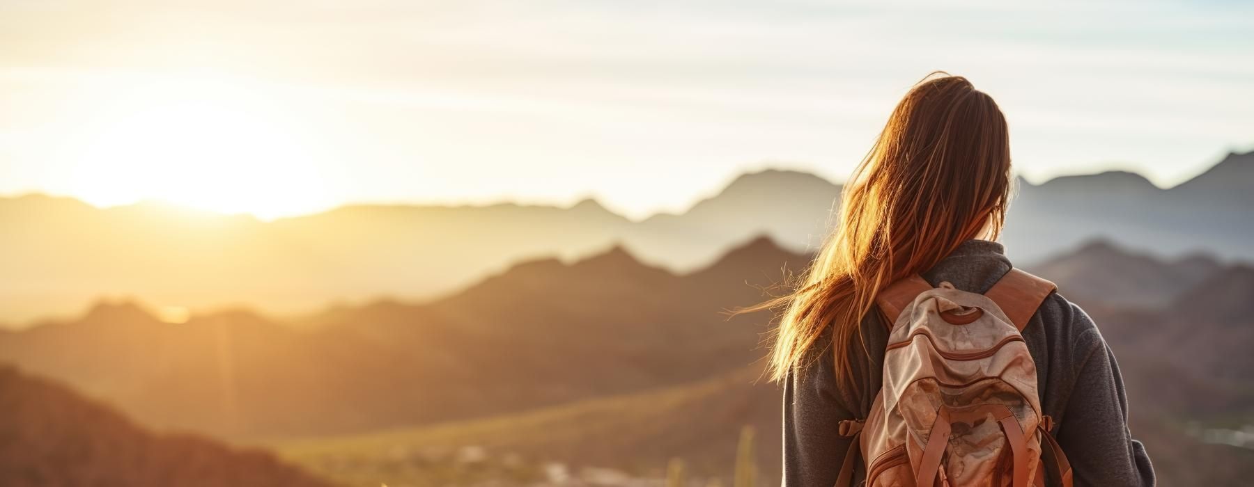 a woman and a dog on a mountain